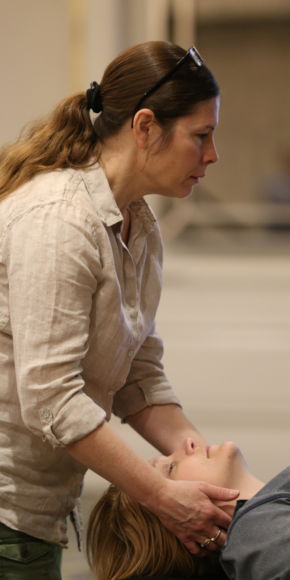 OMT 1 - 1000 x 2000 Woman demonstrates osteopathic manipulative therapy on person