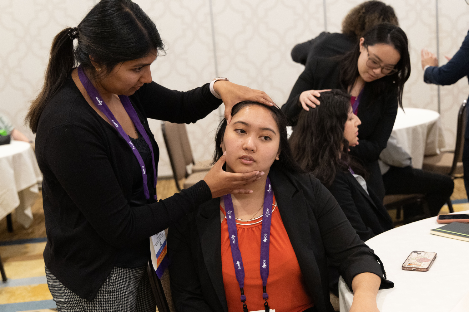 OMT 13 - 1500 x 1000 Woman demonstrates osteopathic manipulative therapy on person