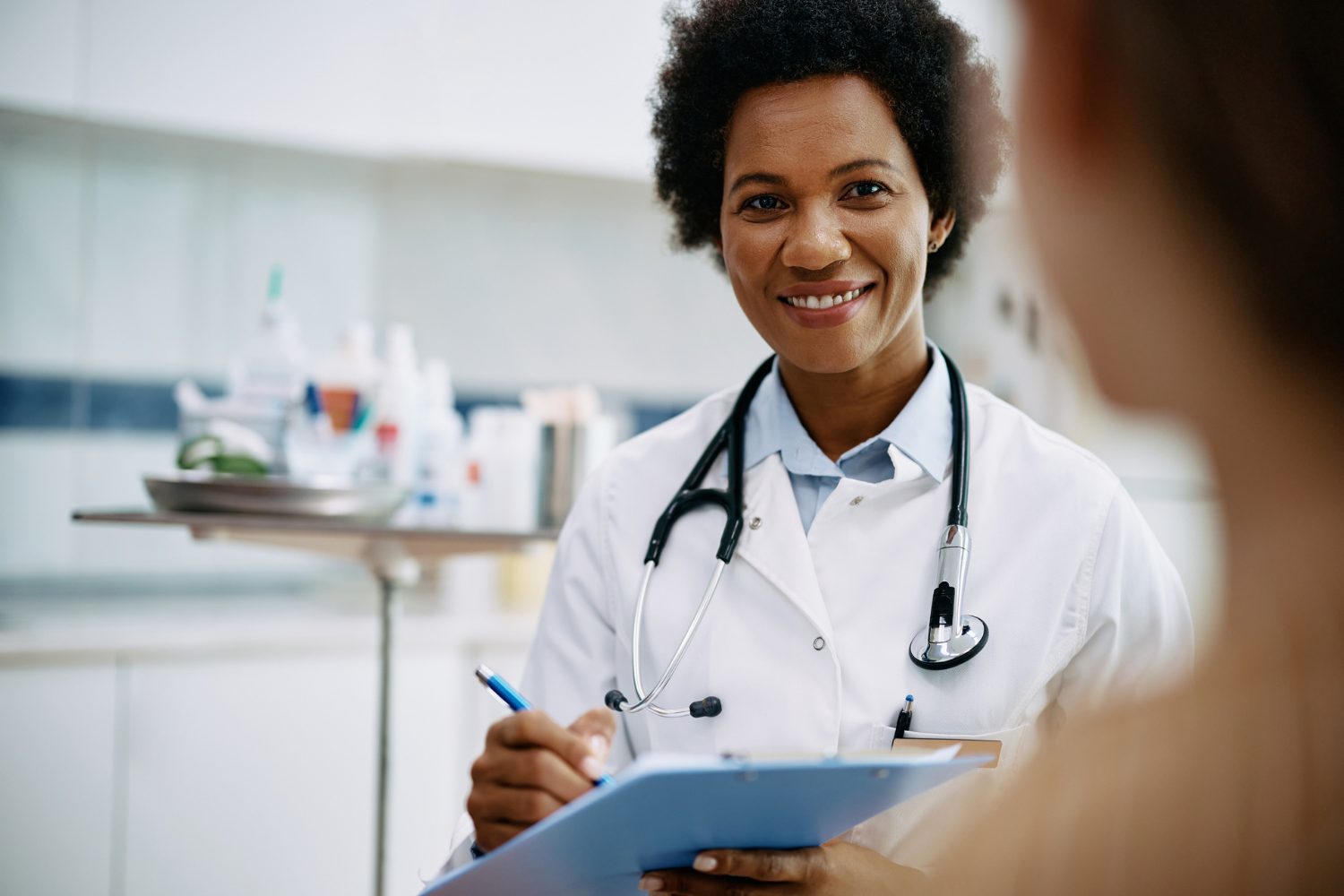 practice management 1500 x 1000 Smiling doctor with clipboard.