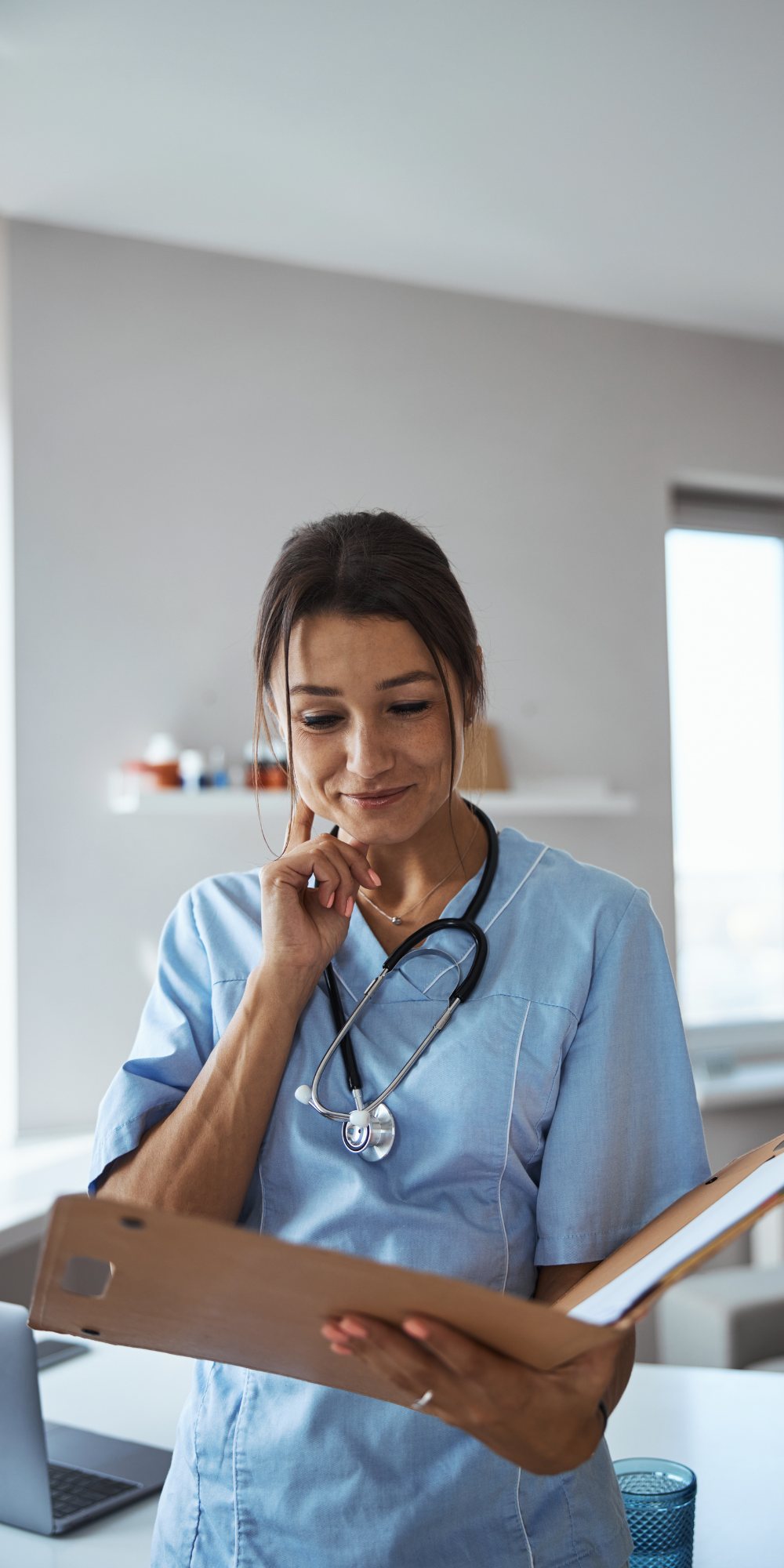 Doctor looking at notes - 1000 x 2000 Doctor looking at folder